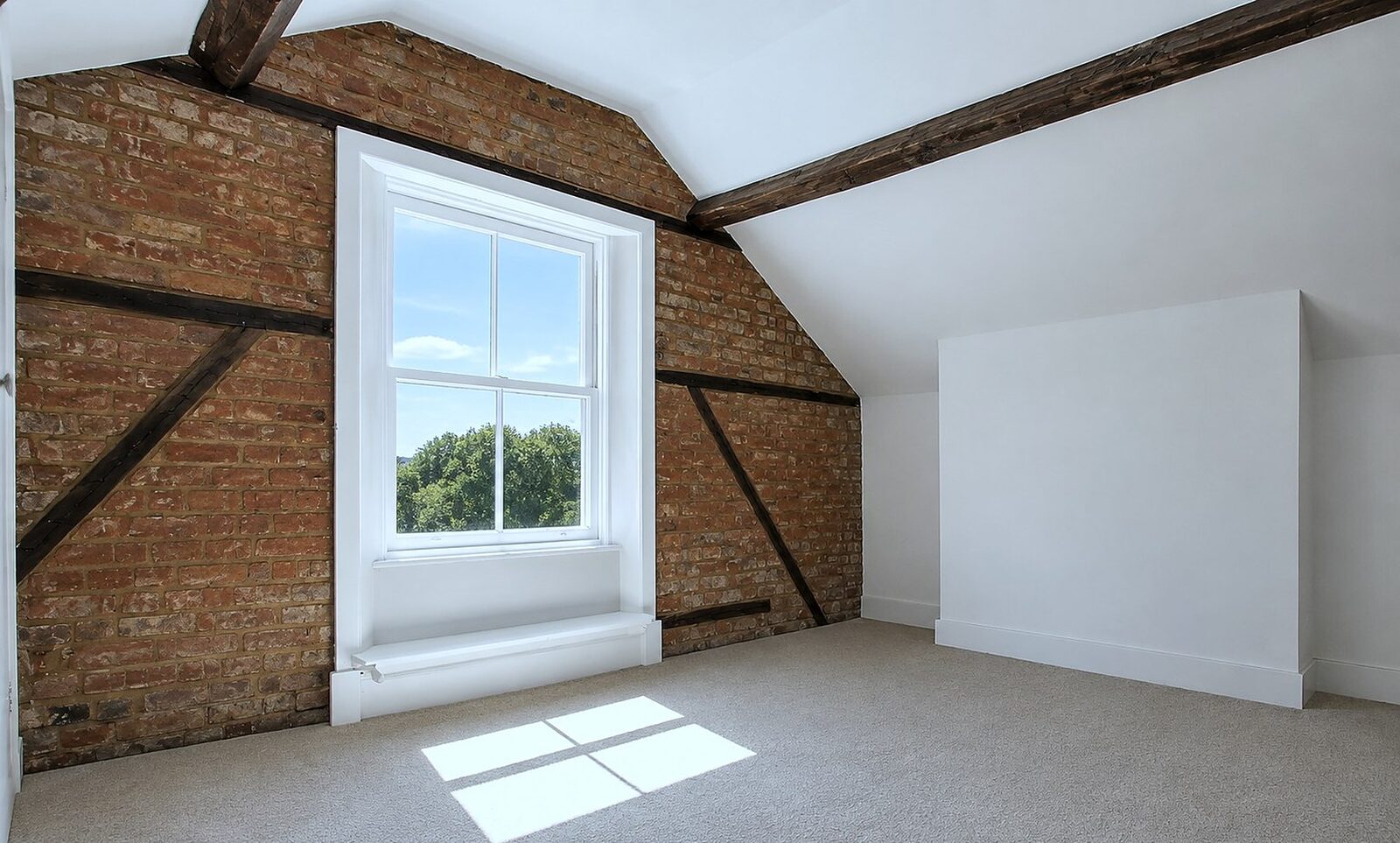 Loft bedroom with exposed brick, timber beams and fresh decoration by Beechurst Services